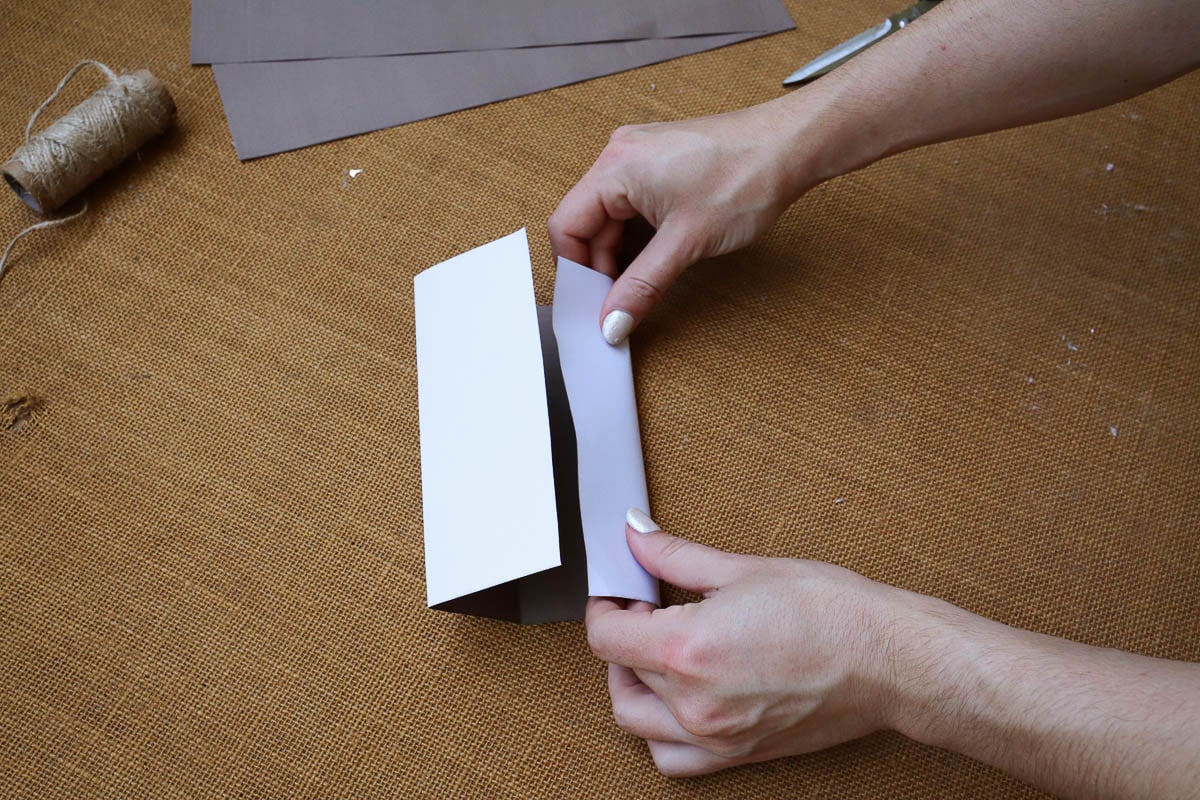 Woman's hand folding paper.