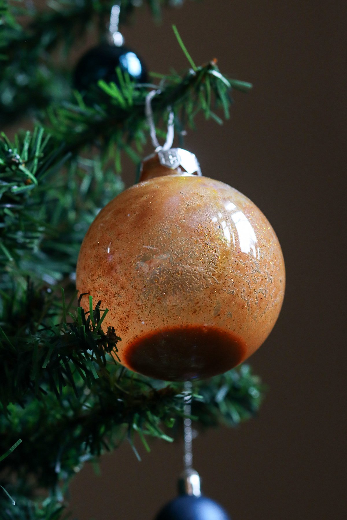 Christmas ornament with paint puddled in the bottom