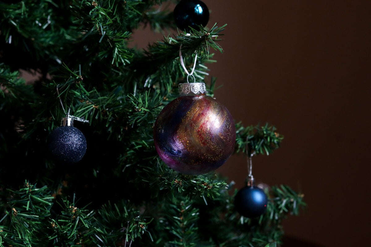 Christmas bauble painted with nail polish to look like a galaxy