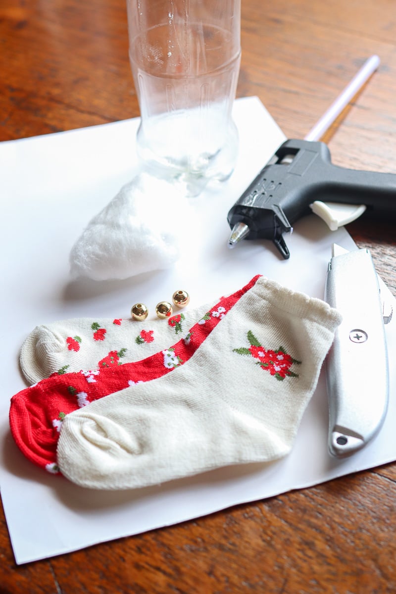 Empty soda bottle, Christmas socks, glue gun