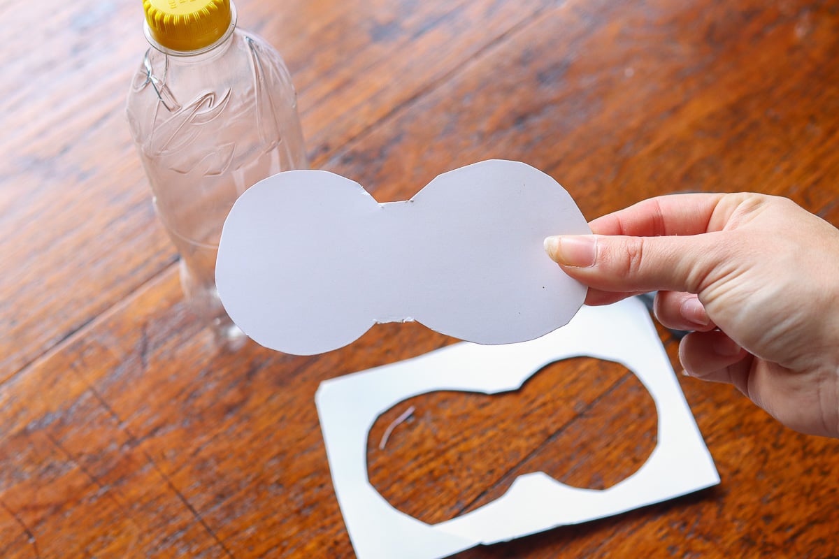 Woman's hand holding boot-shaped card stock