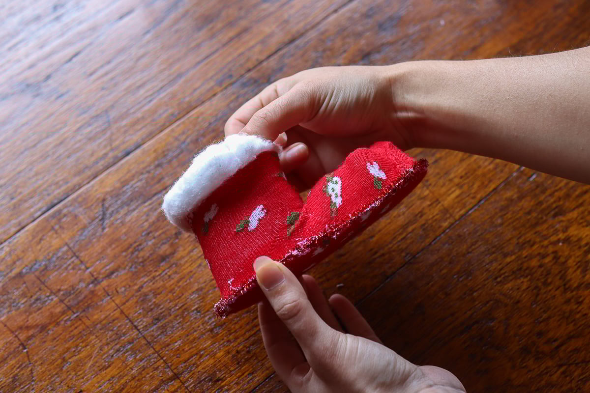 Woman's hand holding Christmas boot