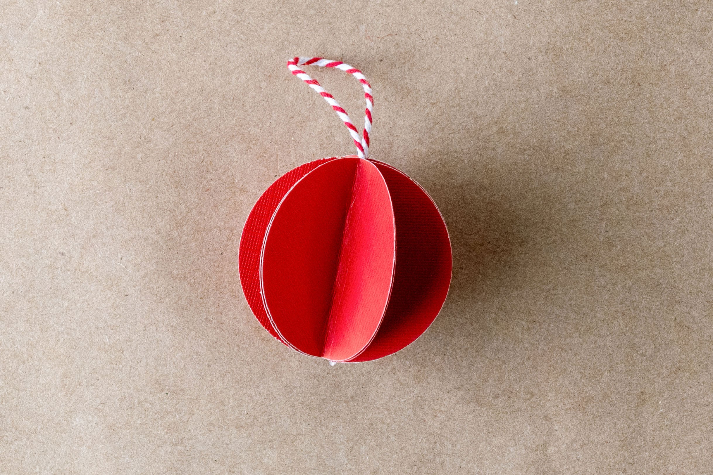 Red 3D paper ornament with twine loop