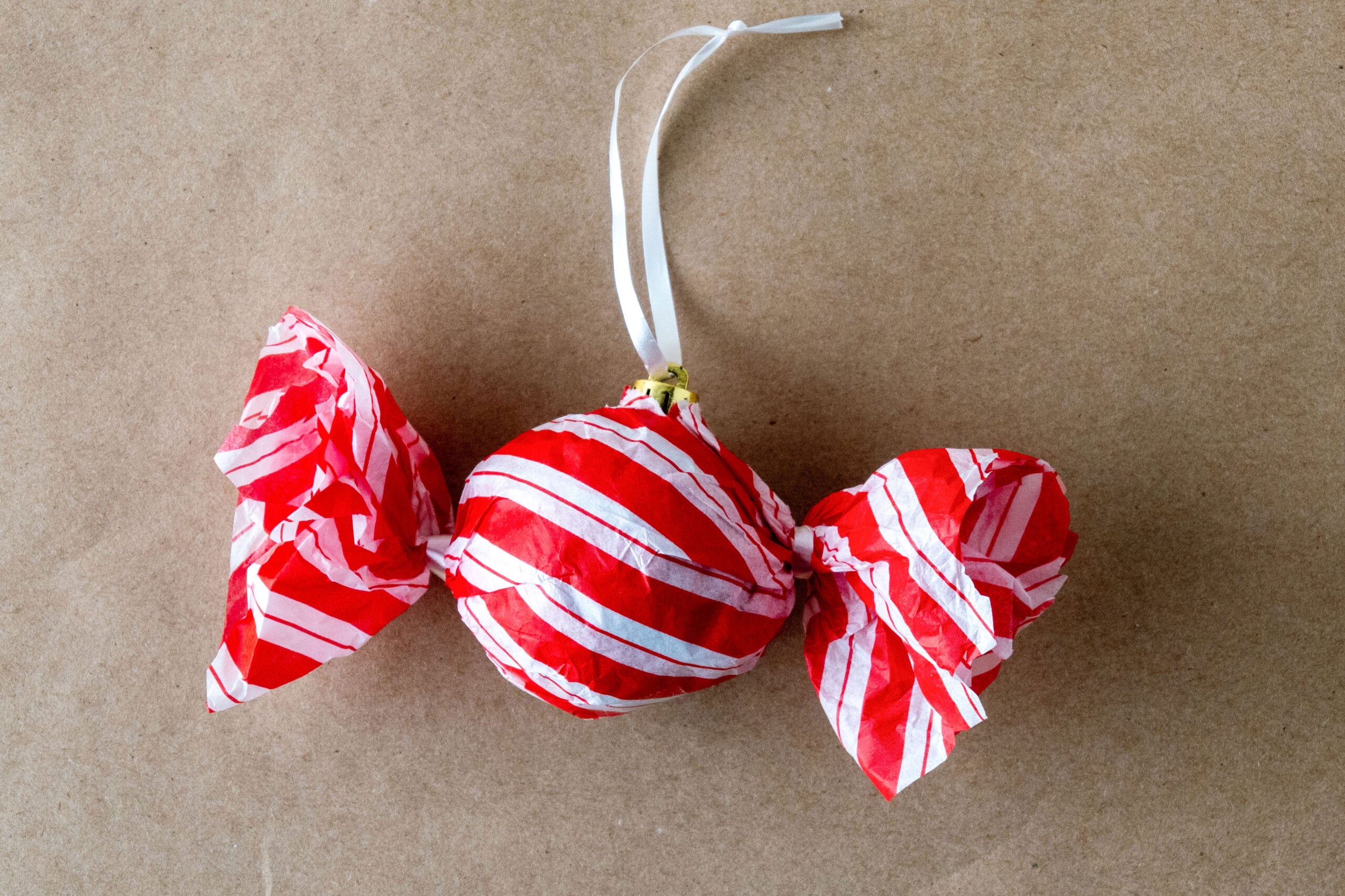 Peppermint striped candy-shaped ornament with loop