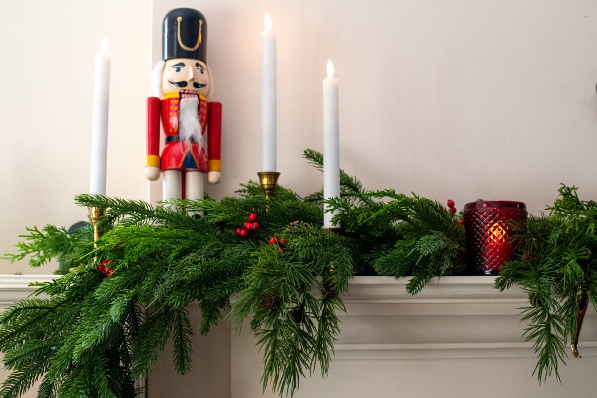 Mantel decorated with faux real touch greenery for Christmas