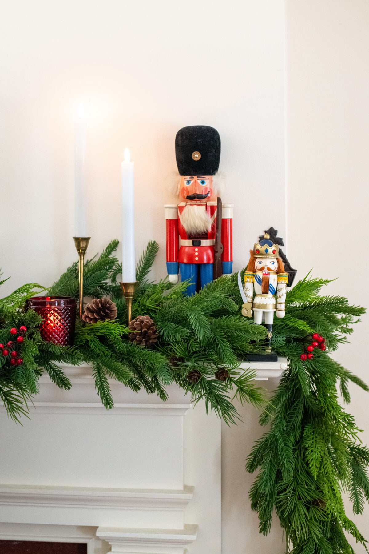 Mantel decorated with faux real touch greenery for Christmas